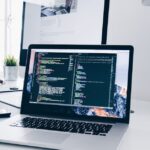 Desktop computer workstation with code on screen