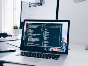 Desktop computer workstation with code on screen