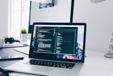 Desktop computer workstation with code on screen