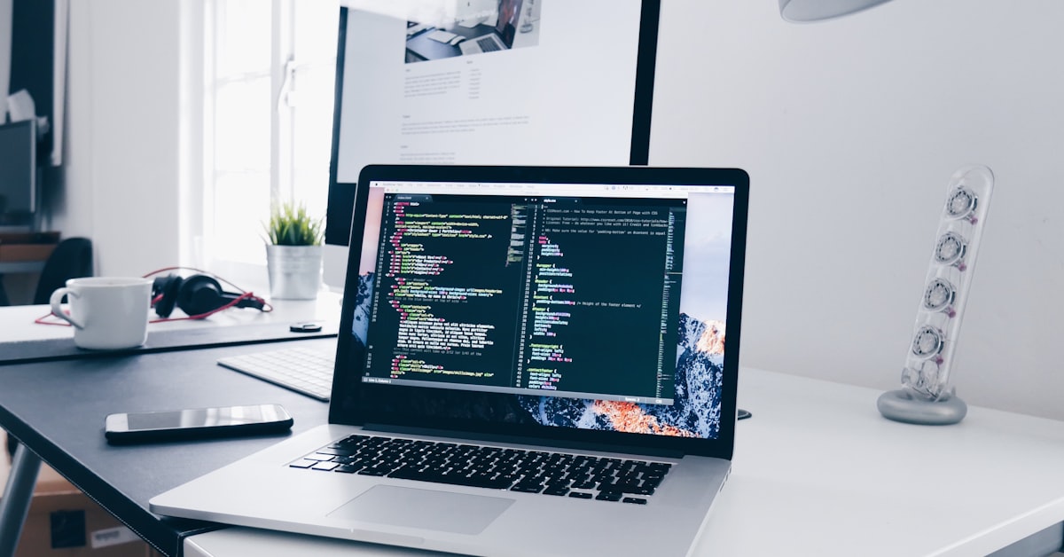 Desktop computer workstation with code on screen