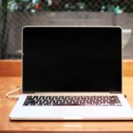 Person comparing laptops to choose the right specifications for their needs