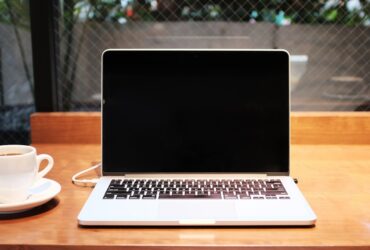 Person comparing laptops to choose the right specifications for their needs