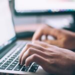 Person working on a laptop representing tech customer support experience