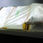 A swollen MacBook Pro battery pack with its foil pouch ballooned inside the casing